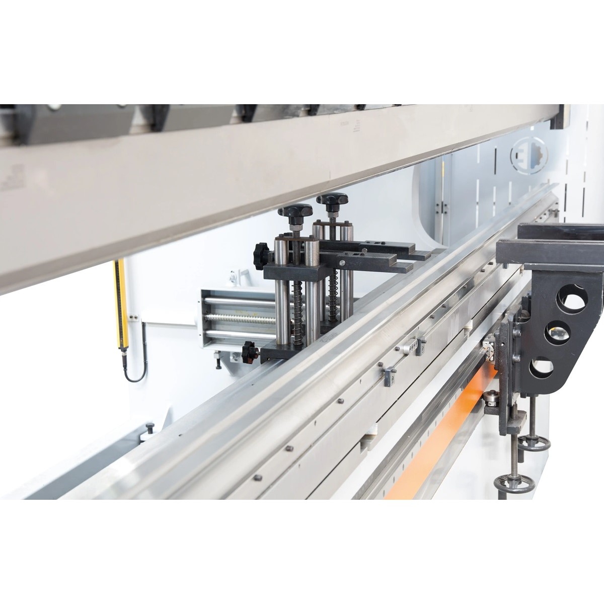 Hinterer Arbeitsbereich der CNC-Abkantpresse mit Anschlägen, Führungsschiene und verstellbaren Haltern.